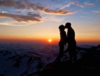 Couple Kissing On Moutain Sunset