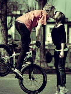 Kiss on bike